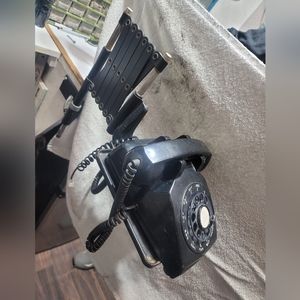 Vintage rotary phone with extension arm.